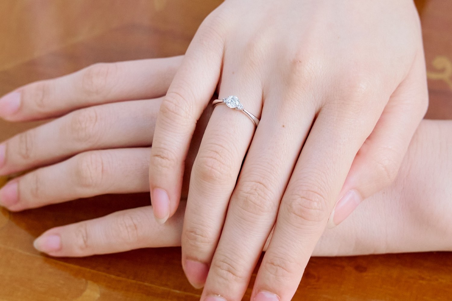 大切なペットのメモリアルダイヤモンドをあしらったリングMDR-103。薬指に着用し、静かに手を重ねた写真。